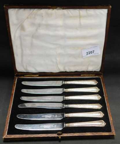 A set of six silver handled butter knives, cased.