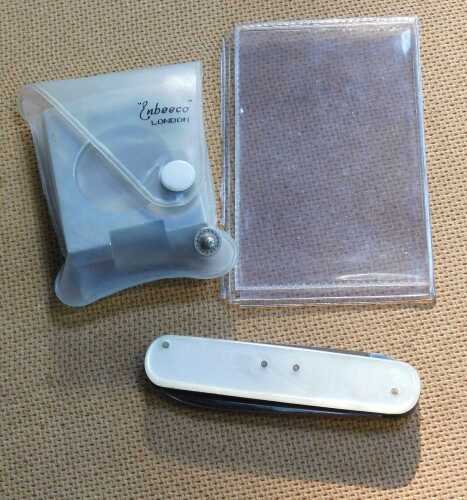 A folding pocket magnifying glass by Endeeco London, and a mother of pearl handled penknife.