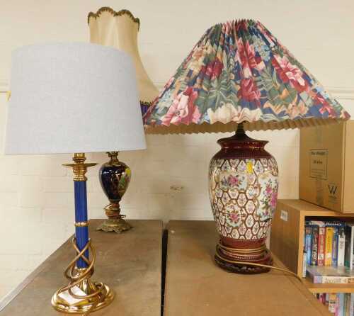 Three table lamps, to include a Continental porcelain example, with decorative reserve within a...
