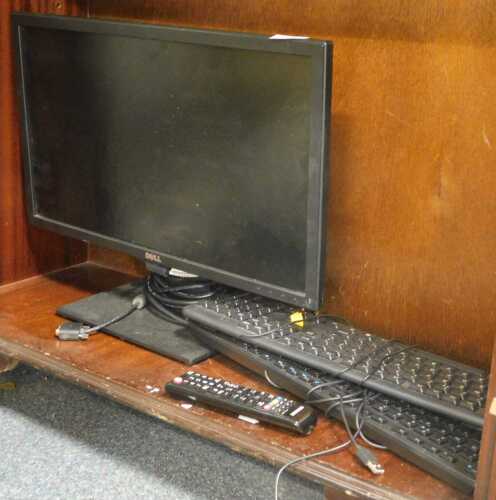 A Dell 22" computer monitor, together with two keyboards, and a Samsung remote control.