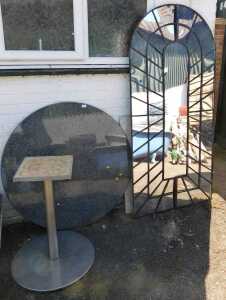 A granite topped circular garden table, with white metal finish base, and a large garden mirror....