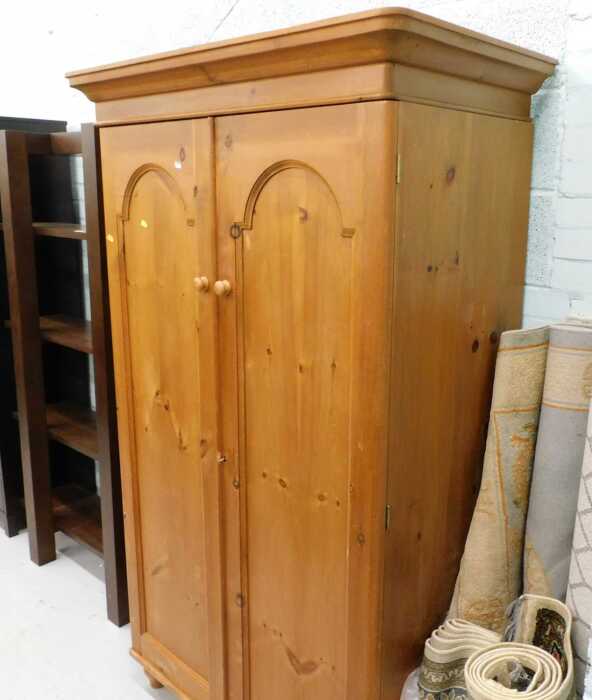 Furniture, a sectional display shelf, a double pine wardrobe, and various rugs.