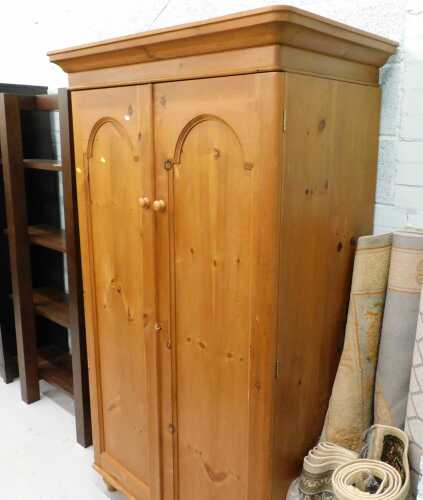 Furniture, a sectional display shelf, a double pine wardrobe, and various rugs.