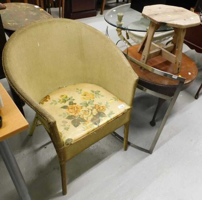 A tub chair, fire guard, rustic stool, and a walnut coffee table.