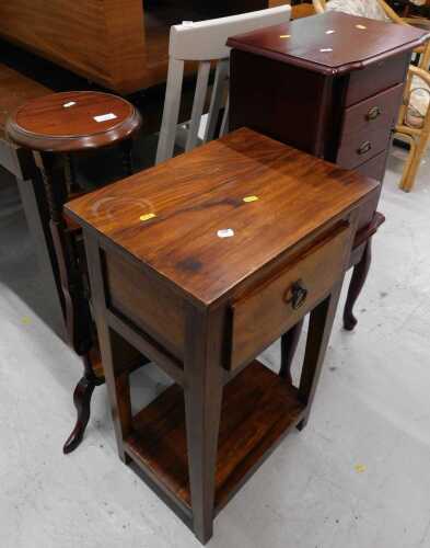 A mahogany finished plant stand, of circular form, with small drawers and under tier beneath,...