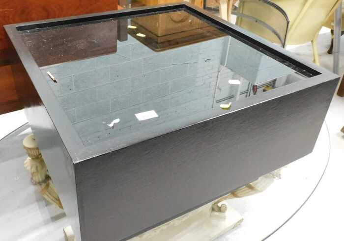 A retro side or coffee table in black, with glazed top.