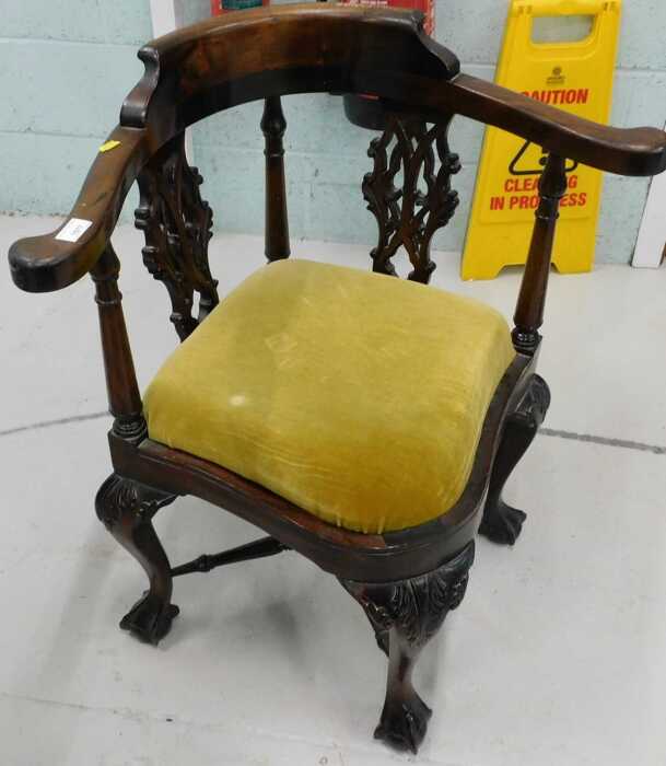 A George III style Chippendale design mahogany corner chair, with shaped seat and heavily carved...