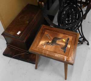 A treadle sewing machine, on iron stand, and an African style table, with antelope copper top. (2)