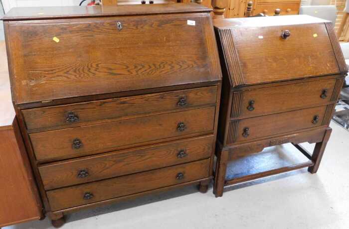 A mid 20thC oak bureau, with fall above four long drawers, and a further bureau.