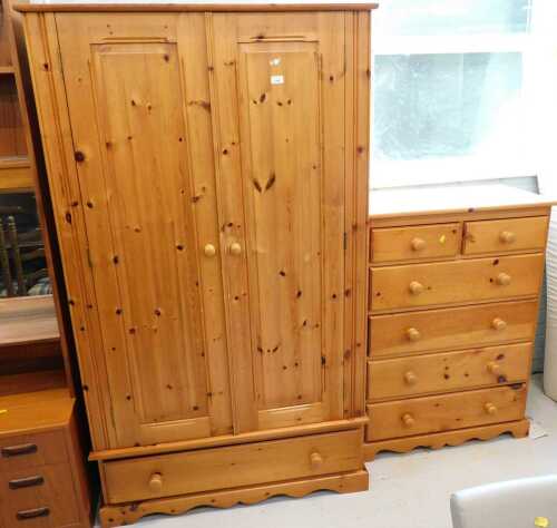 A pine bedroom pair, comprising double door wardrobe and matching chest of two short over four...