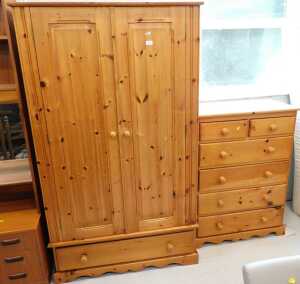 A pine bedroom pair, comprising double door wardrobe and matching chest of two short over four...