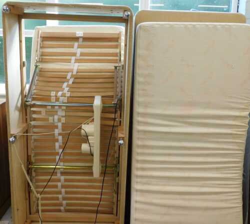 An electric single bed, with adjustable support and shaped 36" wide fitted mattress, with a...