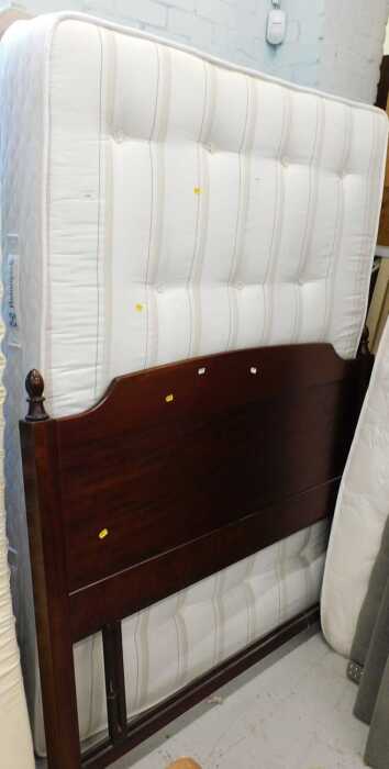 A Sealy Posturepedic 53" wide bed, with divan style base and mahogany finished headboard.
