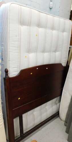 A Sealy Posturepedic 53" wide bed, with divan style base and mahogany finished headboard.