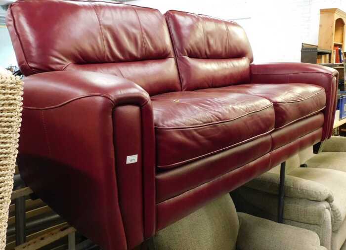 A three seater settee, in burgundy leather.