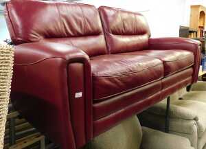 A three seater settee, in burgundy leather.
