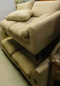 A two piece corner sofa, comprising two parts, with removable cushions, in striped cream material.