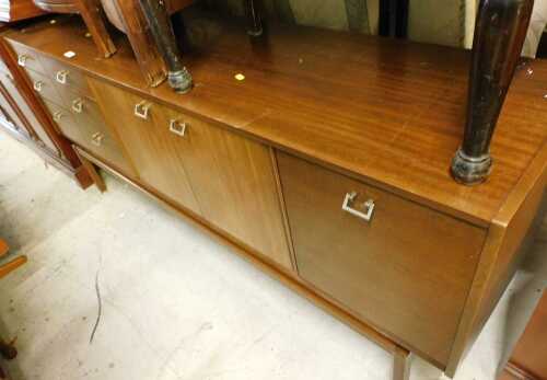 A mid century wooden sideboard, with six short drawers and three door cupboard, square brass...
