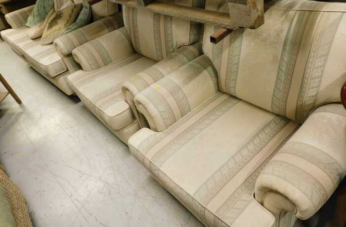 A three piece lounge suite, comprising three seater settee and two armchairs, in Regency style...