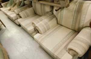 A three piece lounge suite, comprising three seater settee and two armchairs, in Regency style...