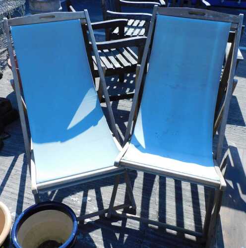 Two folding deck chairs, in green material.