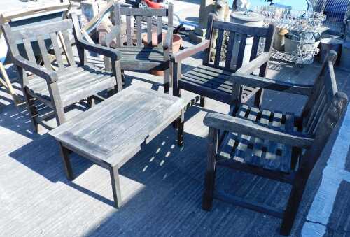 A stained slatted garden patio set, comprising rectangular coffee table and four chairs.