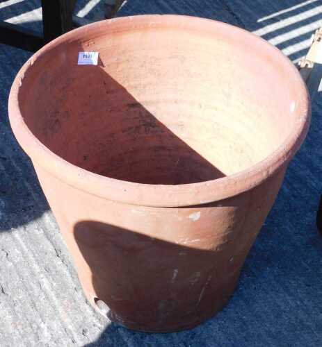 A redware fire clay style planter, of tapering circular form, with lower hole for tap.