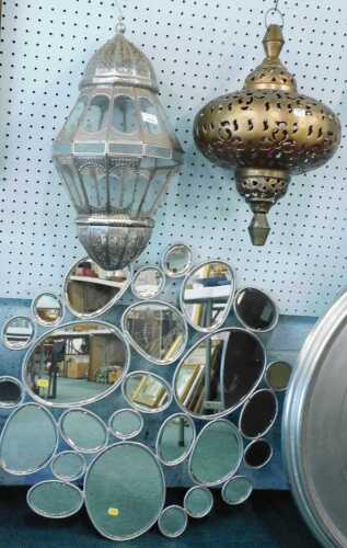 Two hanging lanterns, and an elaborate shaped mirror.
