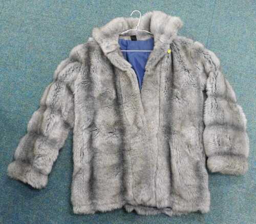 A grey three quarter length fur coat.