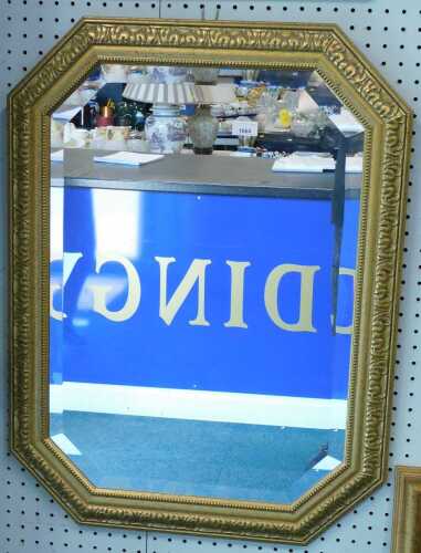 An octagonal hanging mirror with bevelled glass.