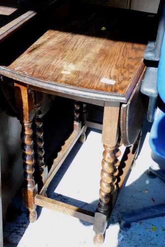 A 20thC oak barley twist gate leg D-end dining table.