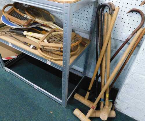 Various vintage tennis rackets, croquet mallets, walking sticks, etc. (a quantity)