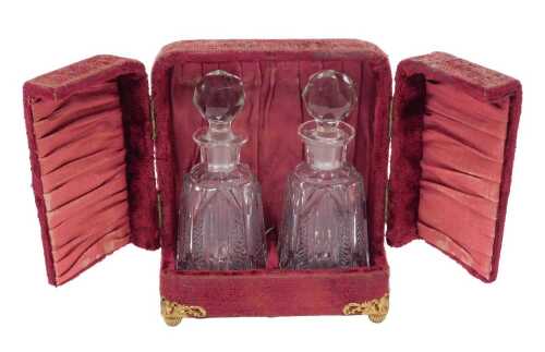An Edwardian travelling miniature decanter or perfume bottle set, comprising two bottles in...