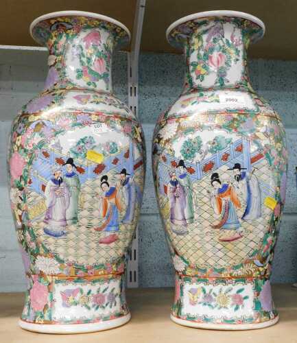 A pair of Oriental style vases, decorated with flowers and figures, 46cm high.