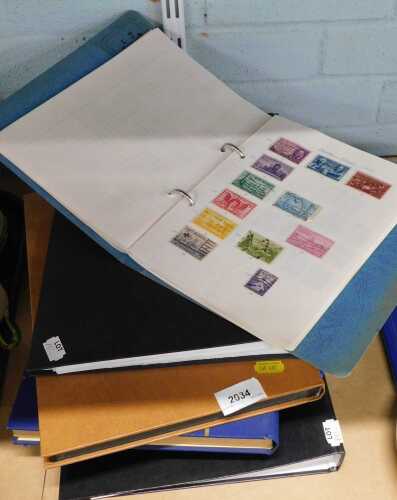 Five albums of world stamps.