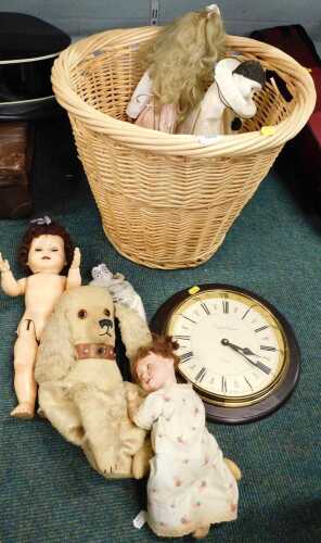 A large wicker basket, English Elegance Essex wall clock, a quantity of dolls, to include early...
