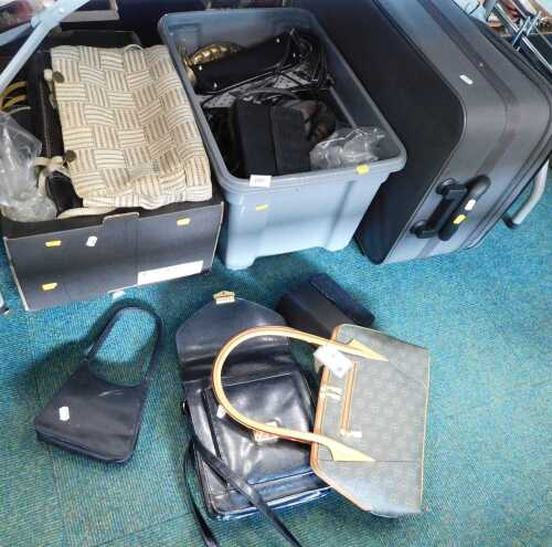 Various handbags, together with a large grey suitcase.