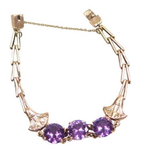 A mystic topaz bracelet, set with three round brilliant cut stones, each in a raised four claw...