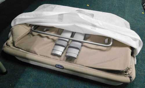 A Chicco folding travel cot.