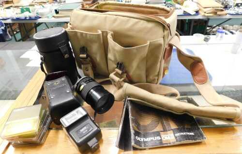 A gold coloured canvas camera bag, 32cm wide, containing a quantity of various camera related...
