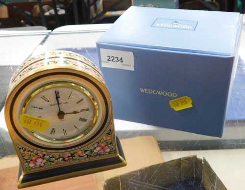 A Wedgwood bone china Cleo quartz clock, boxed.
