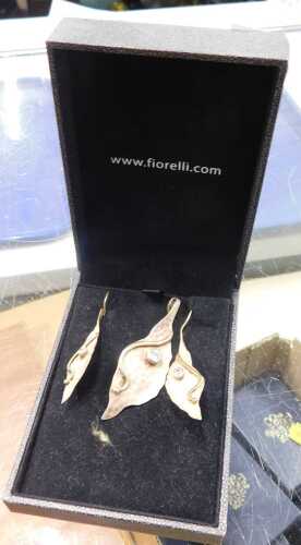 A Fiorelli fancy jewellery set, comprising a pair of earrings and pendant, each of naturalistic...