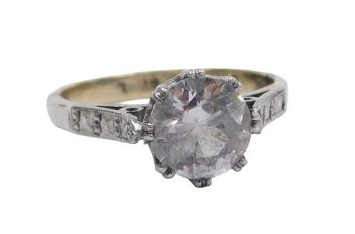 A single stone dress ring, set with large central imitation diamond in a raised claw basket...