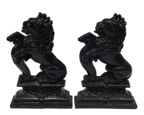 A pair of 19thC cast iron door stops, in the form of rampant lions aside scrolls on stepped...