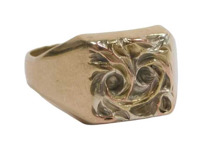 A signet ring, the twist design ring head in bicolour finish, on a yellow metal band, with...