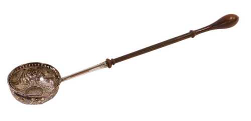 A George III toddy ladle, with heavily repousse decorated bowl, centred by a coin, with turned...