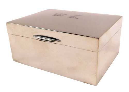 A George VI silver cigarette box, of rectangular form, with crests to the lid and plain cedar...