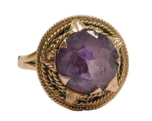 A mystic topaz dress ring, in the eastern style with halo border and sun moulded design on rope...