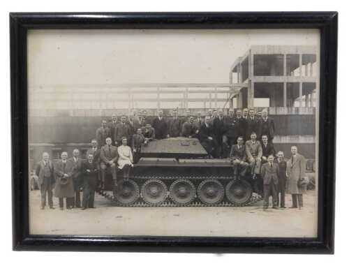 A mid-20thC black and white photograph of a British tank, surrounded by civilian workers and...