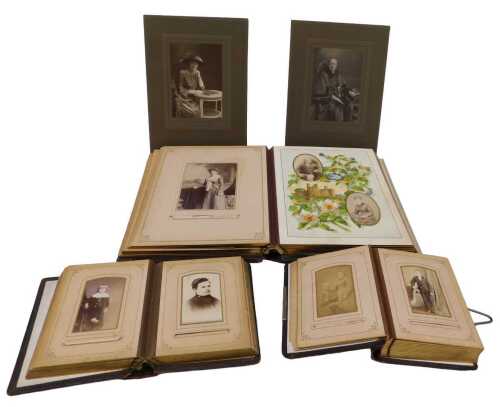Three various late Victorian or Edwardian photograph albums, to include a quantity of various...